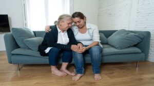 Sad Senior Mother and Daughter Embracing Each Other Grieving Loss of Loved Ones