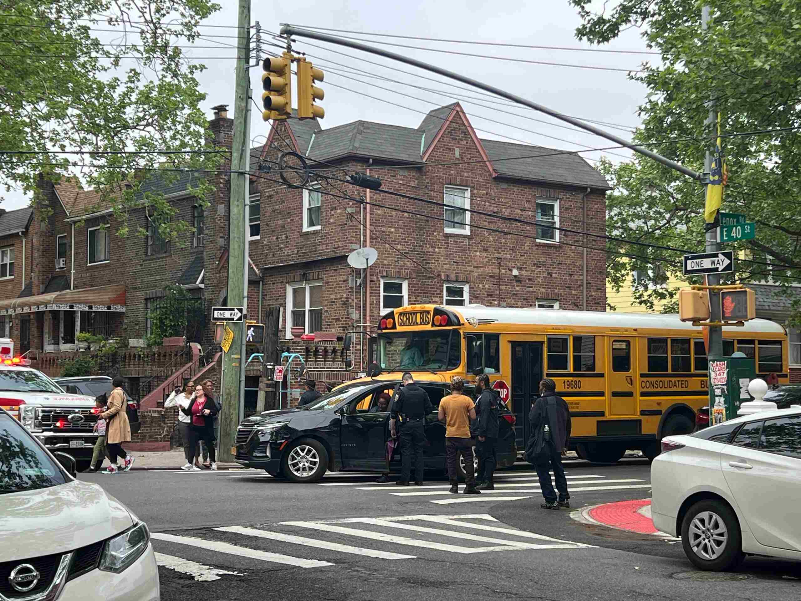Police officers and emergency responders inspect a school bus collision site supported by Troy bus accident lawyers.