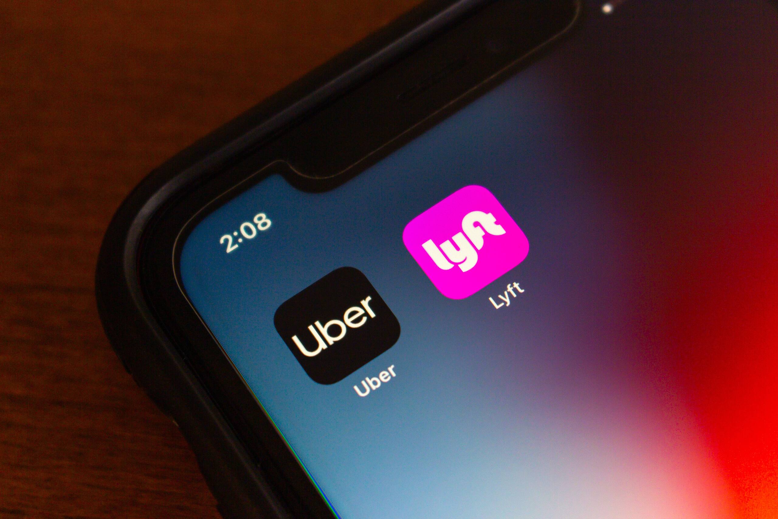 A smartphone screen displaying the Uber and Lyft app icons representing cases managed by Southfield Rideshare Accident Lawyers