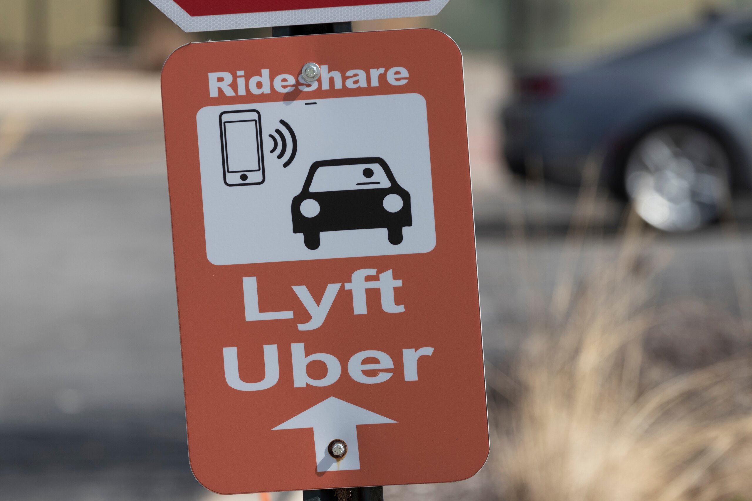 A rideshare sign pointing to Lyft and Uber pickup areas representing services supported by Grand Rapids Rideshare Accident Lawyers.