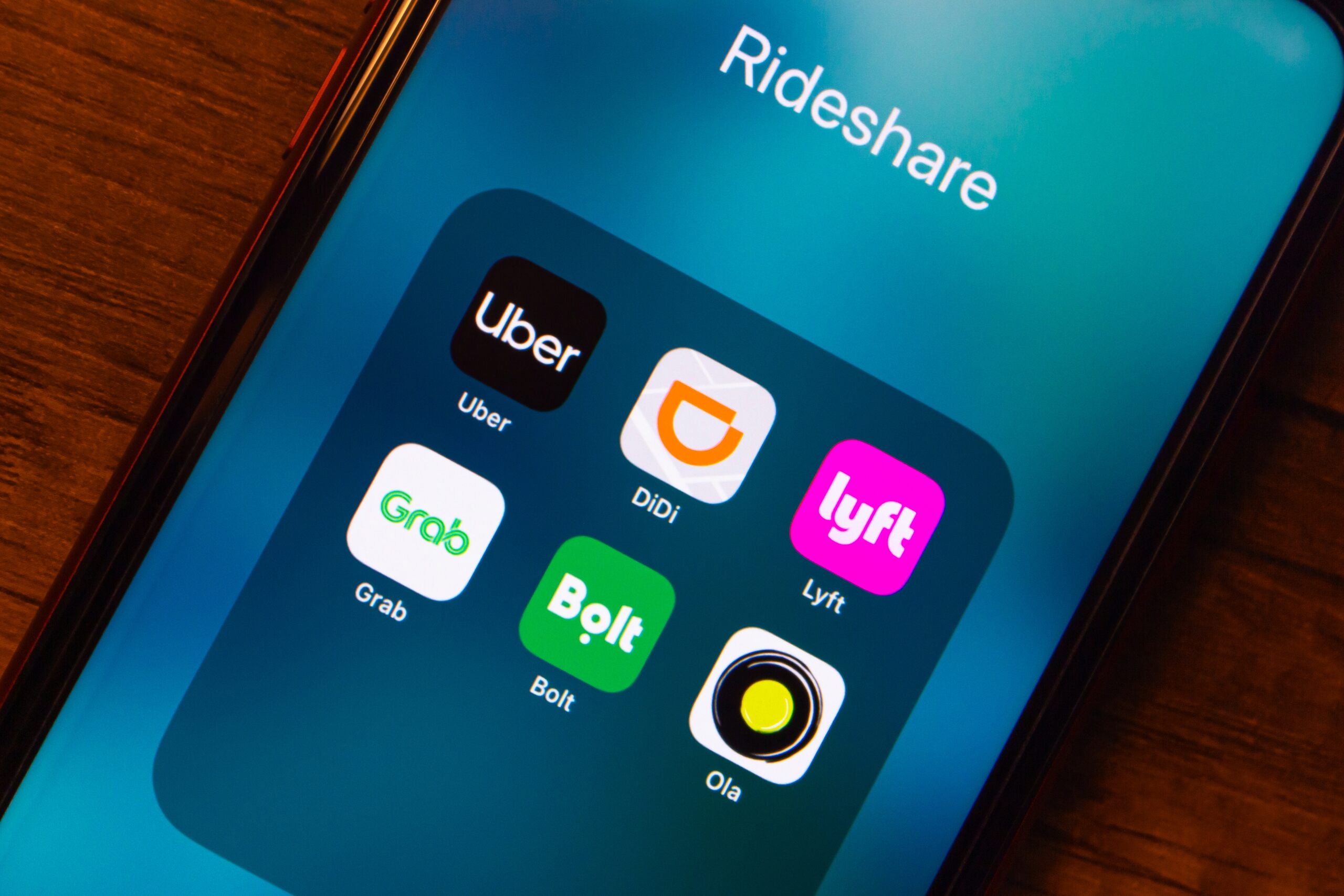 A smartphone screen displaying Uber and Lyft applications representing claims handled by Detroit Rideshare Accident Lawyers.
